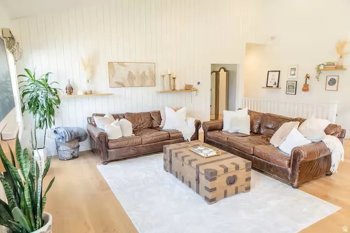 Vaulted ceilings complement the light wood-finish flooring