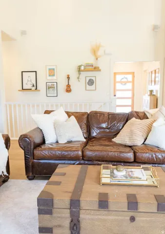 Spacious living area featuring vaulted ceilings and light wood-finish flooring