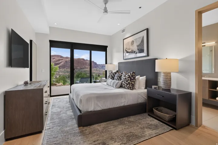 Spacious room featuring floor-to-ceiling sliding glass doors, light wood-finish flooring, a contemporary ceiling fan, and recessed lighting