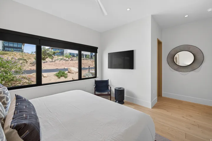 Spacious room featuring light wood-finish flooring, white walls, and recessed lighting