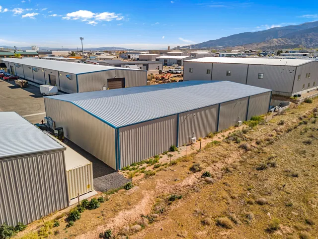 Spacious industrial facility featuring corrugated metal siding and a blue-trimmed metal roof