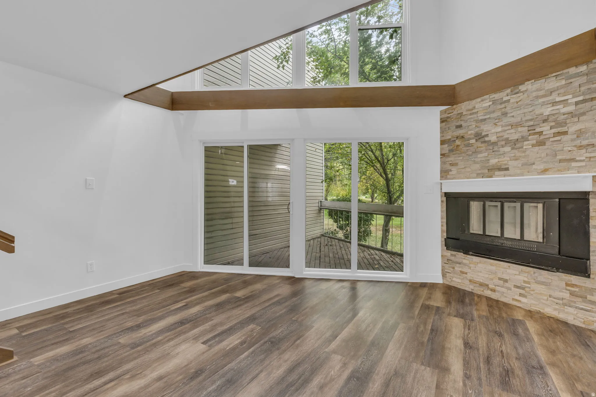 Corner fireplace with stone surround and white mantel