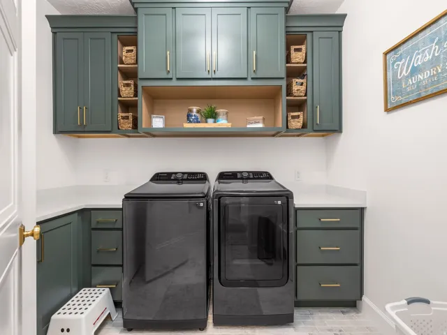 Laundry room featuring shaker-style cabinetry, quartz countertops, a built-in shelf, and wood-finish open shelving