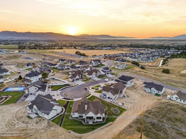 Residential development featuring modern single-family homes with dark roofs and light siding