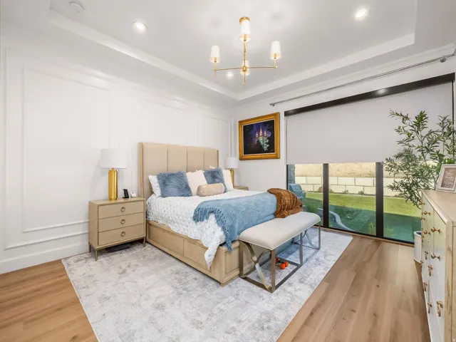 Bedroom featuring wood-finish flooring, recessed lighting, and a modern gold-toned chandelier