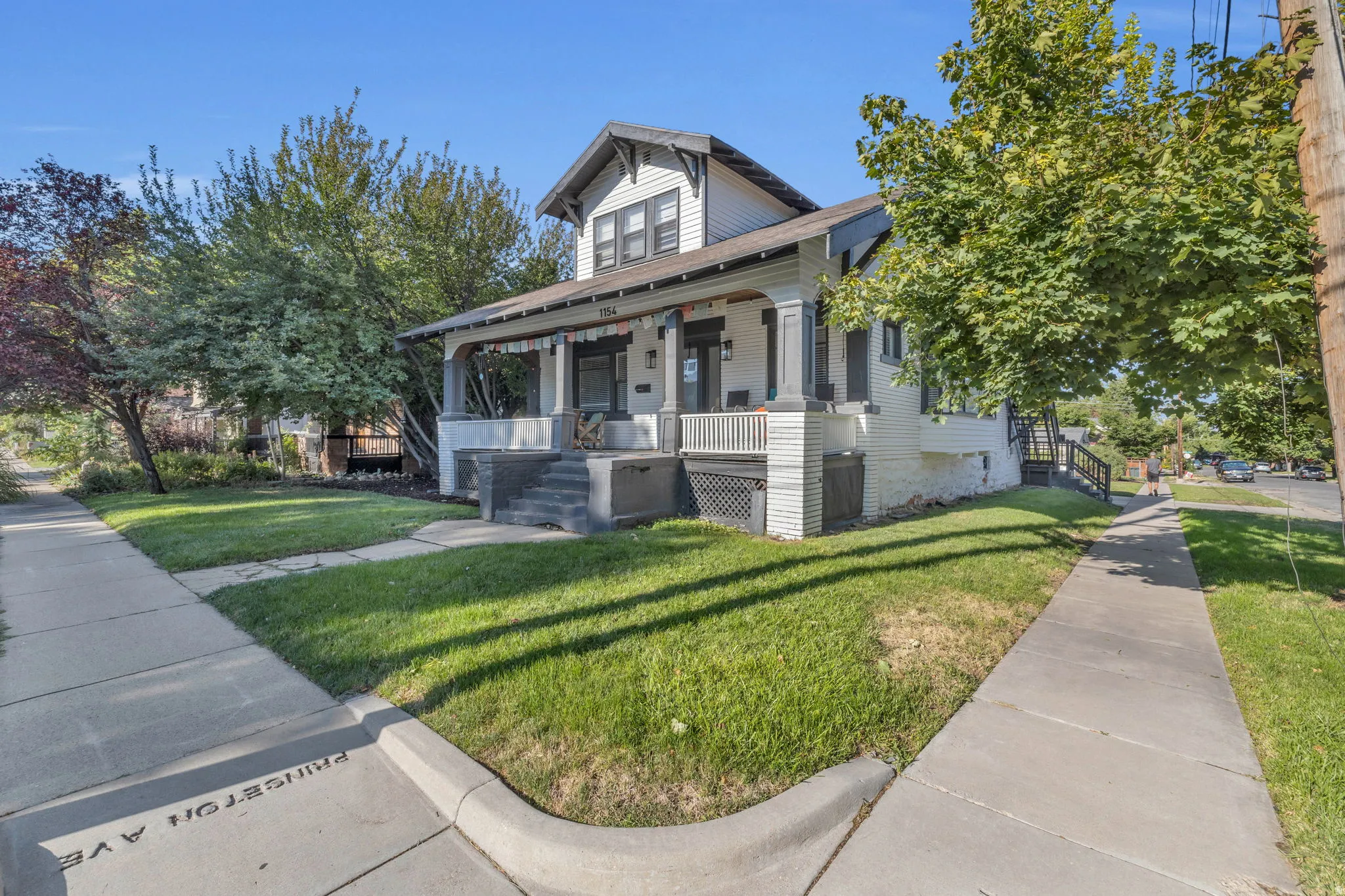 Craftsman-style home featuring a covered front porch with substantial columns, a gabled roofline, and dormer windows