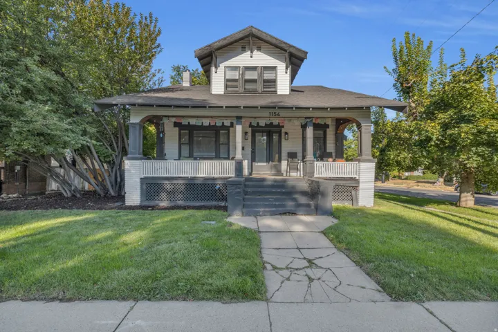 Craftsman-style residence featuring a prominent gabled roofline and an inviting covered front porch