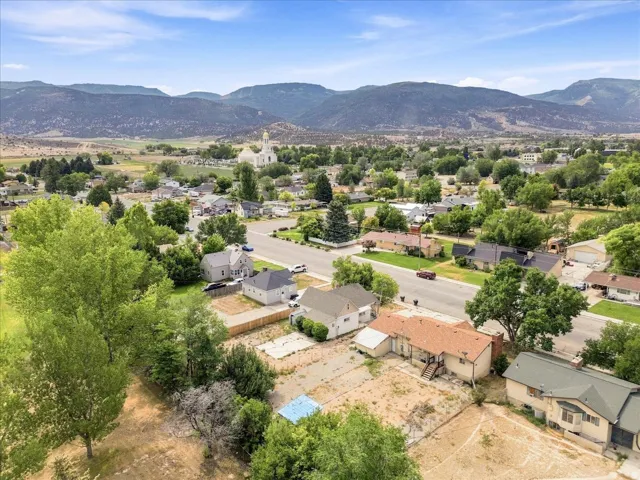 Aerial perspective showcasing residential properties with surrounding mountainous terrain