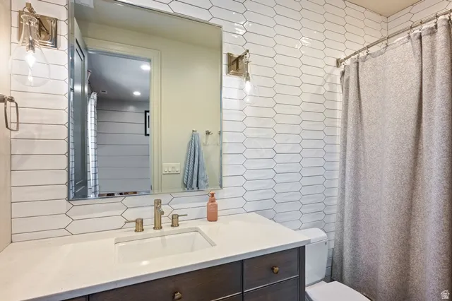Bathroom featuring a dark wood vanity with a white countertop and integrated rectangular sink