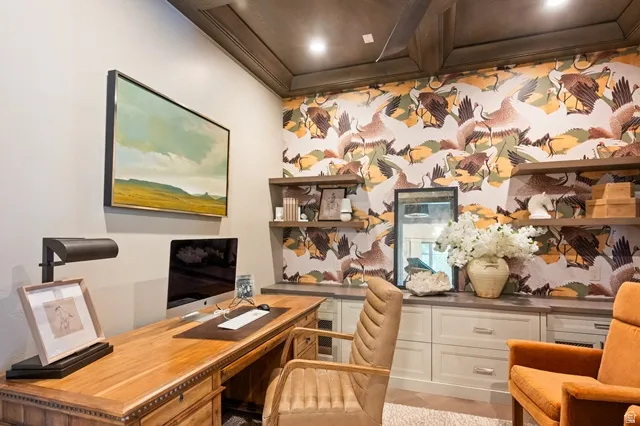 Dedicated workspace featuring a coffered wood-paneled ceiling