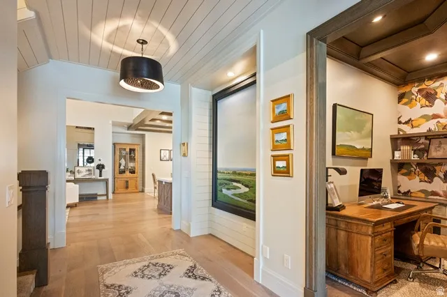 Interior entryway featuring wood-finish flooring and a decorative chandelier