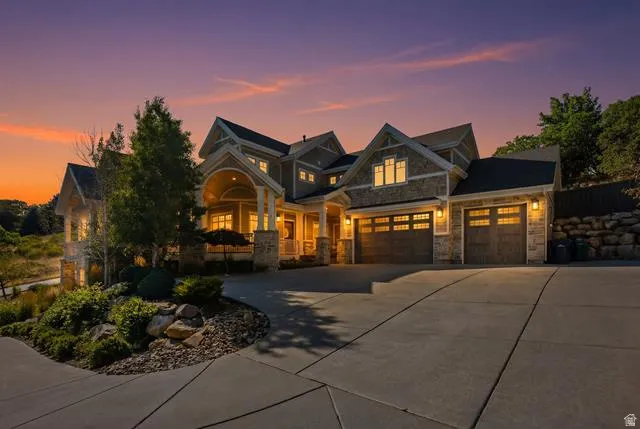 Stone and siding exterior with multiple gables and a covered front entry