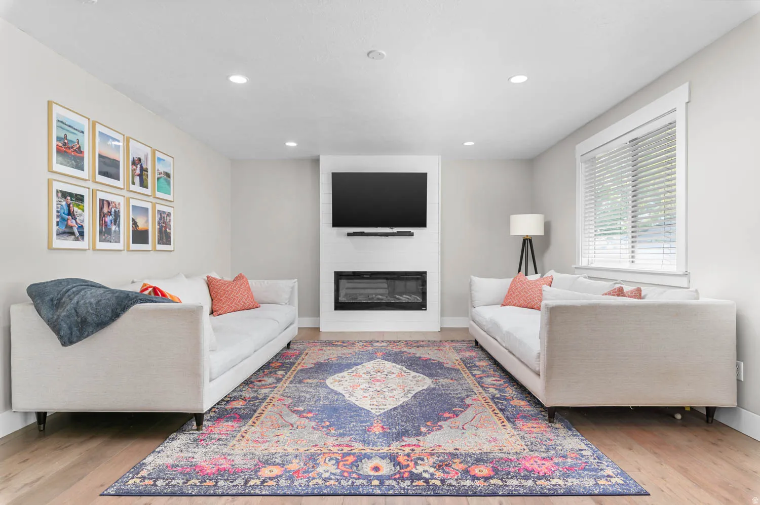 Living area featuring light wood-finish flooring, recessed lighting, and a built-in media center with an electric fireplace
