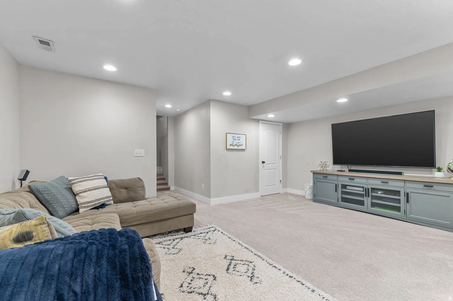 Finished lower level with neutral carpeting