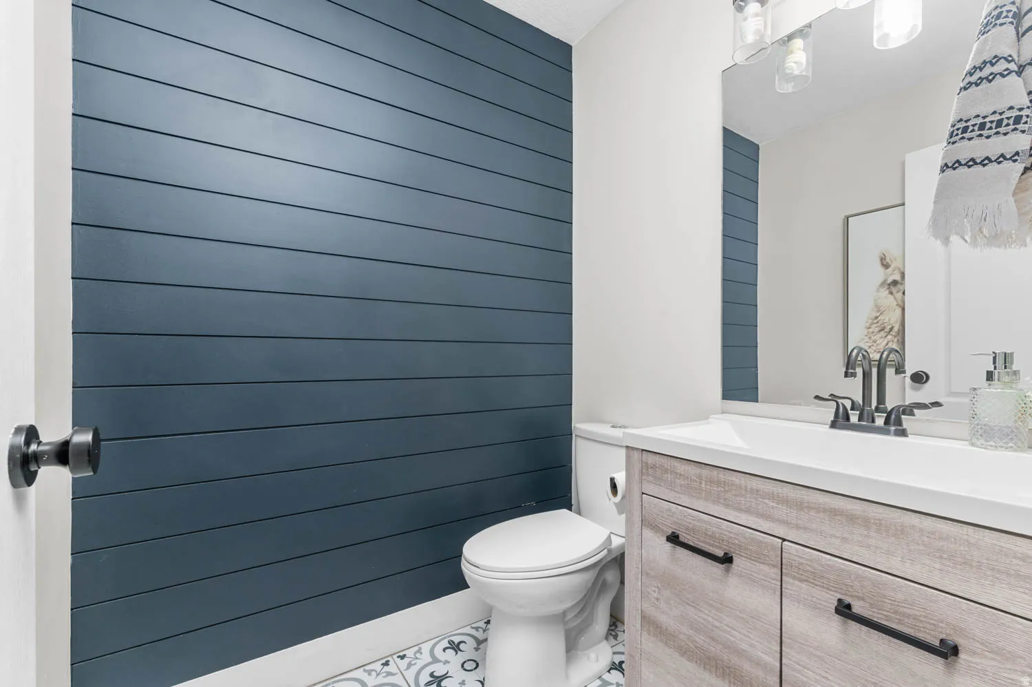Accent wall with horizontal plank detailing, complemented by patterned floor tiles