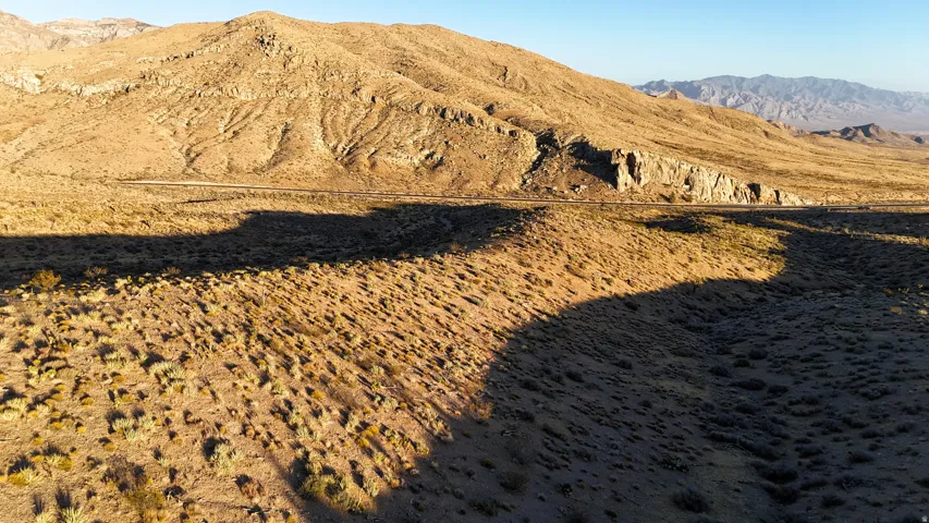 Expansive desert landscape featuring rugged mountain terrain and natural vegetation