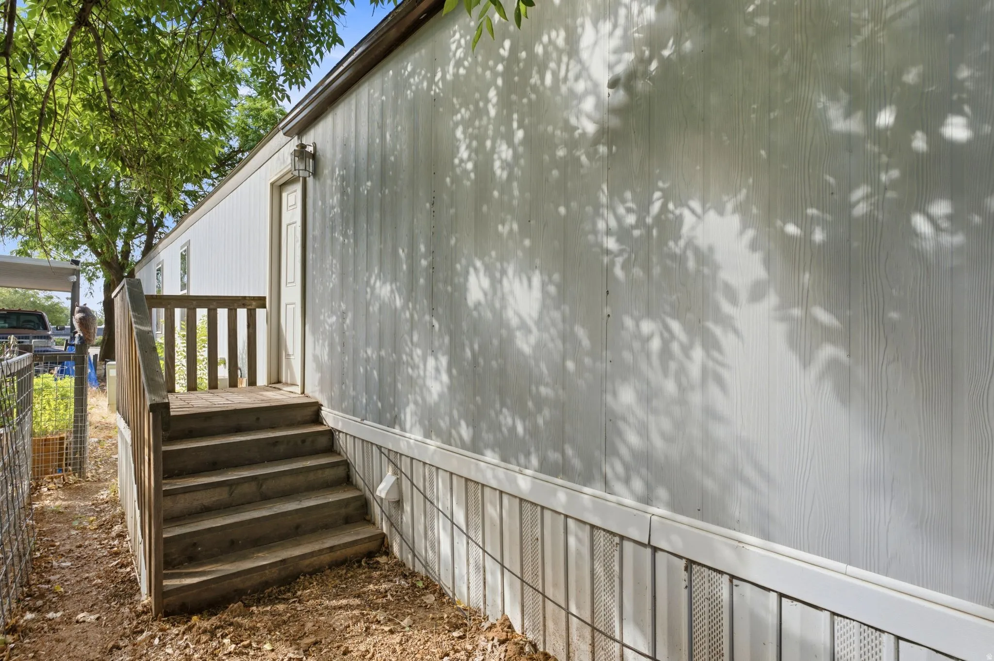 White board-and-batten style siding with a contrasting skirting