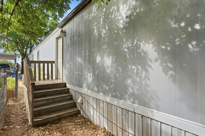 White board-and-batten style siding with a contrasting skirting