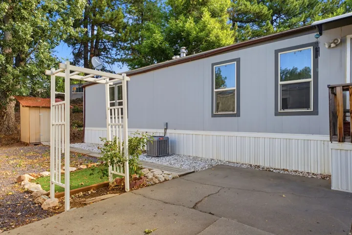 Property exterior featuring light gray siding with dark trim windows