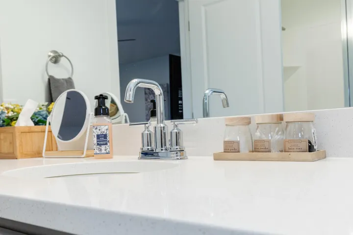 White countertop with integrated sink and chrome faucet