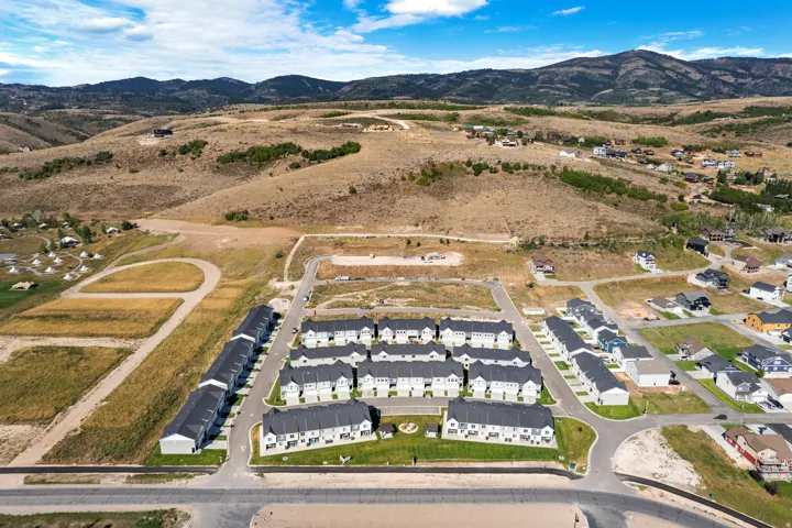 Expansive aerial perspective showcasing a residential community with numerous newly constructed homes