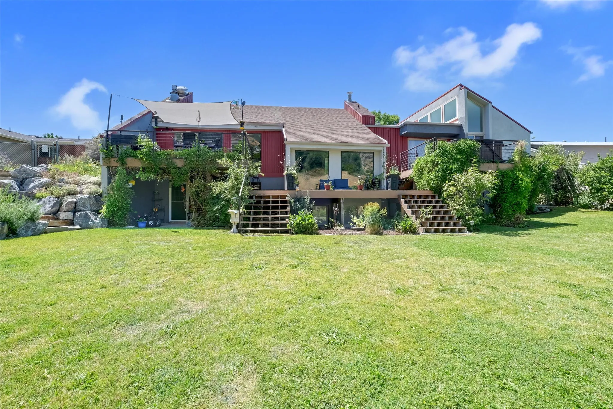 Expansive green lawn providing access to a multi-level deck