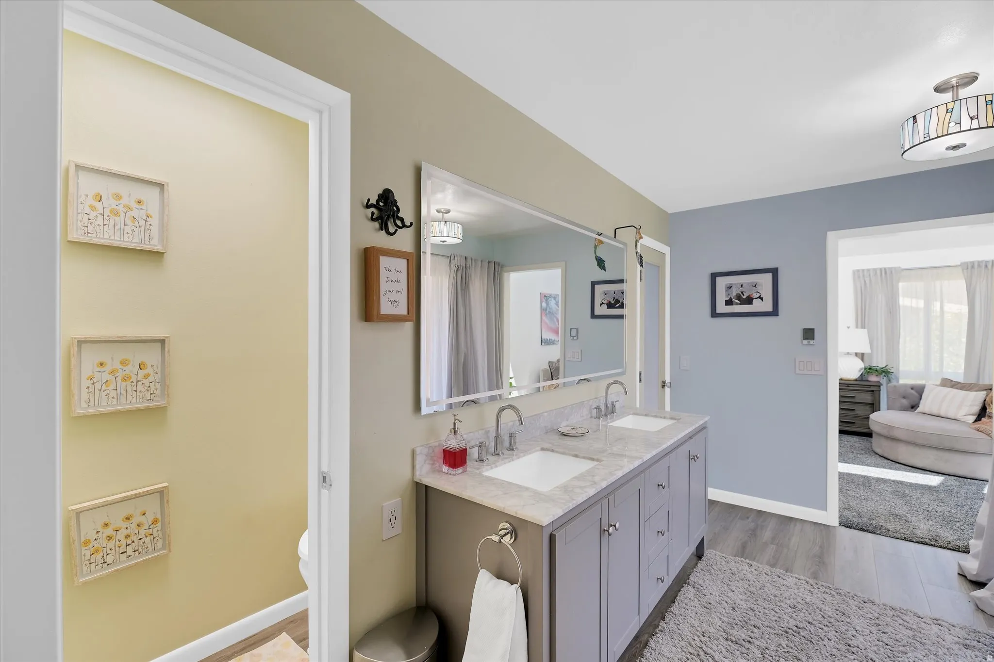 Dual vanity with undermount sinks, stone-finish countertop, and chrome fixtures
