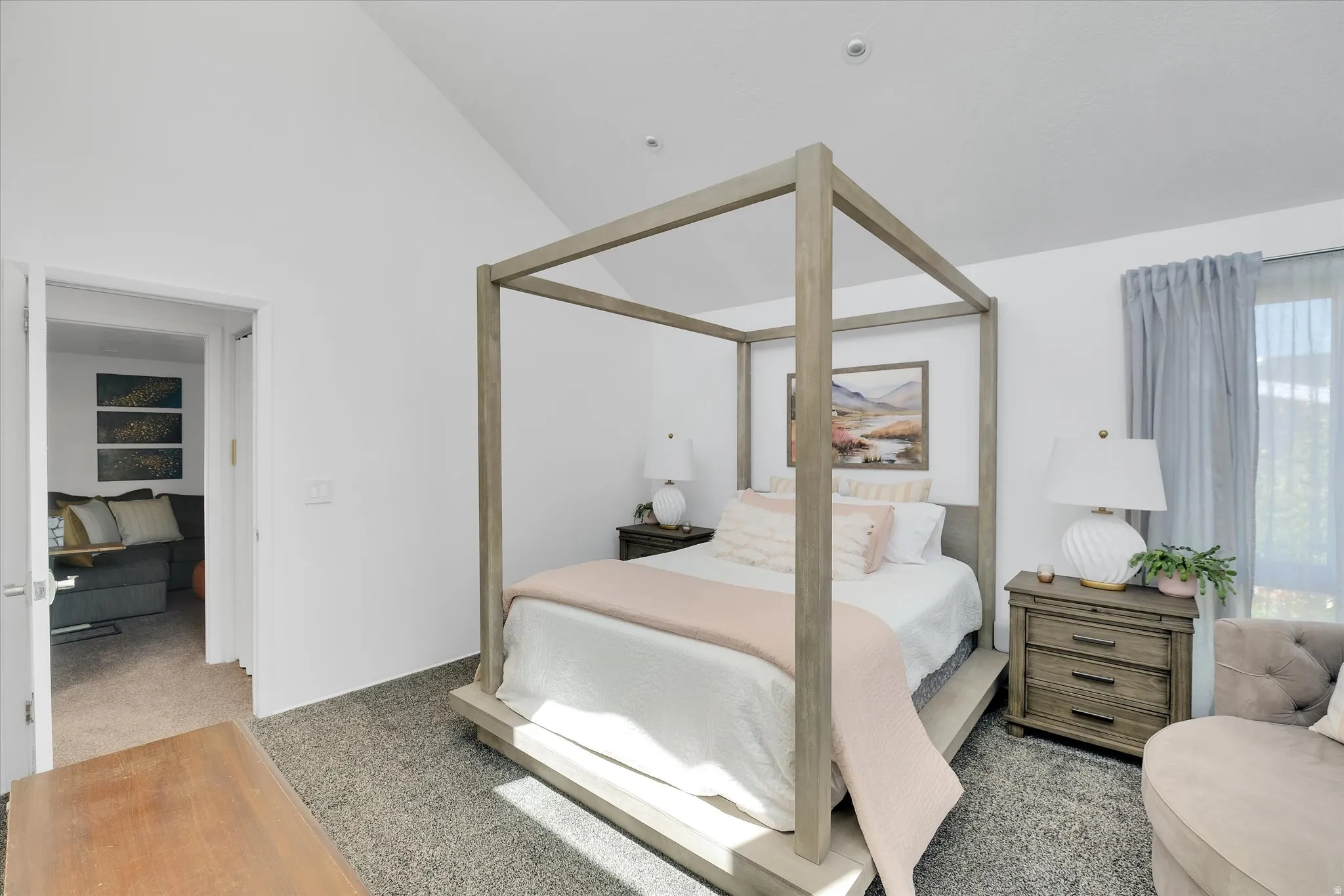 Vaulted ceiling room with wood-finish flooring