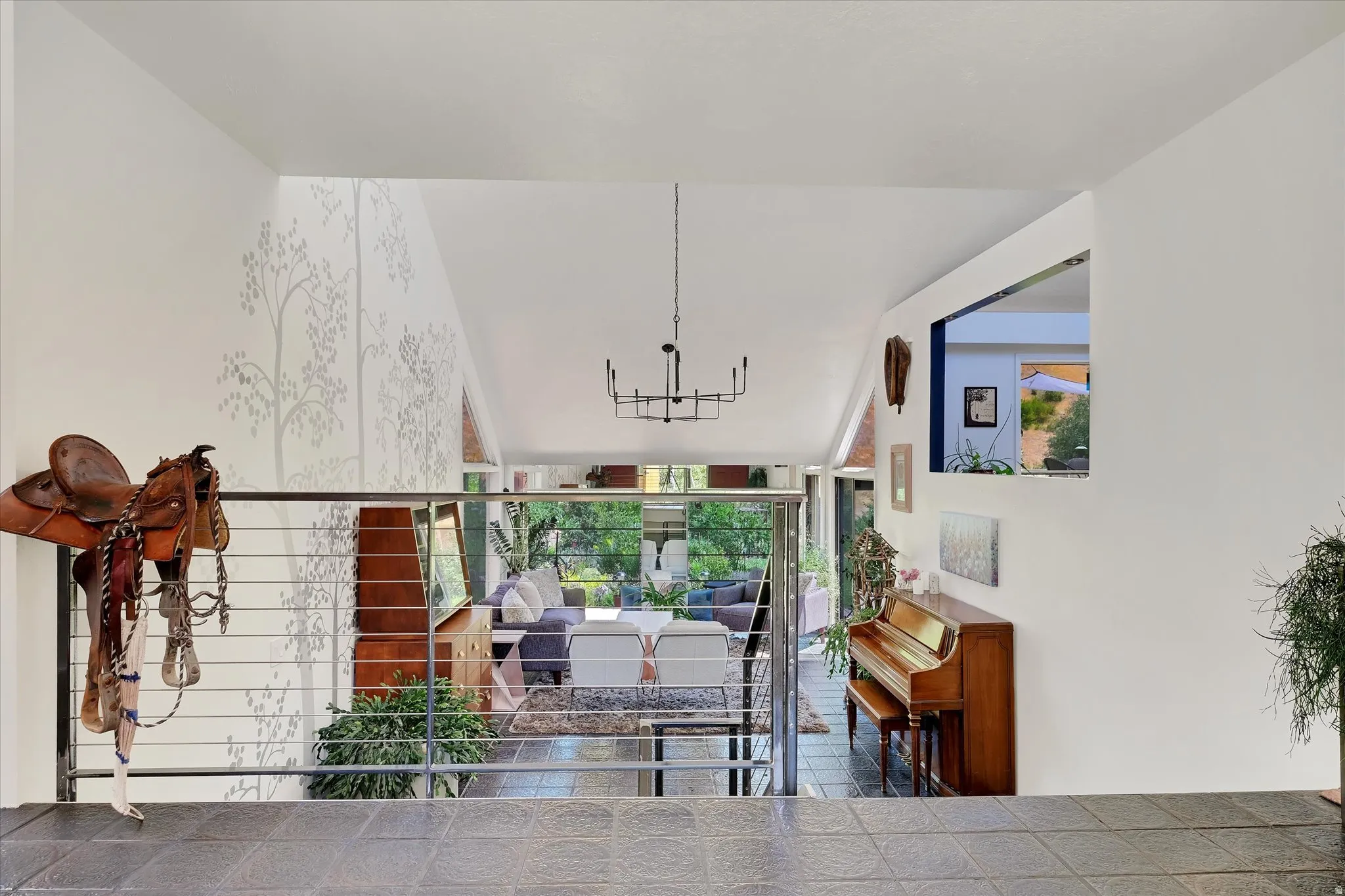 Split-level entry with slate tile flooring and a cable railing system