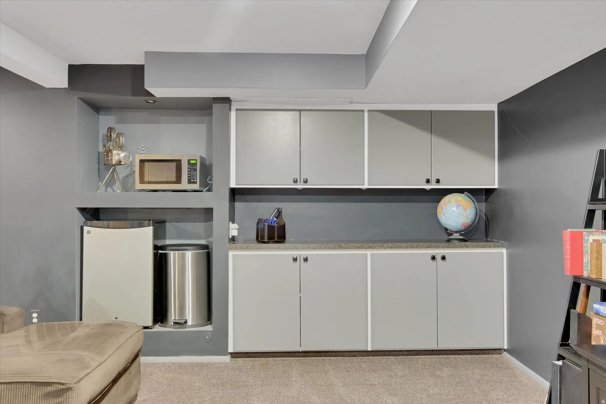 Built-in custom cabinetry with light gray doors and black hardware
