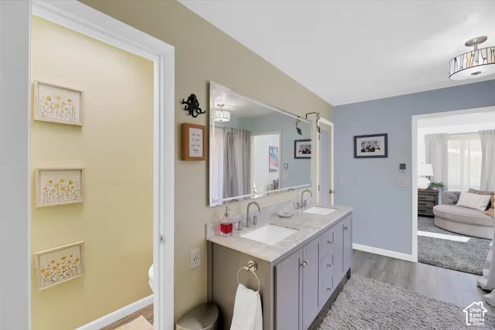 Dual vanity with undermount sinks, stone-finish countertop, and chrome fixtures