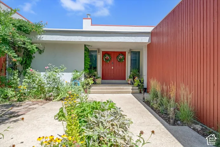 Modernist facade featuring a prominent red double-door entry