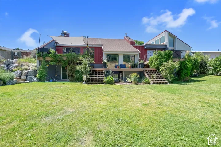 Expansive green lawn providing access to a multi-level deck