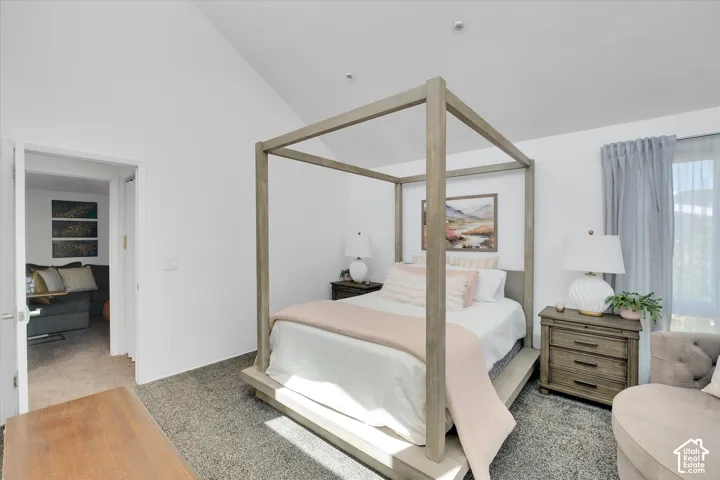 Vaulted ceiling room with wood-finish flooring
