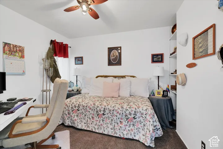 Bedroom featuring white walls and textured carpeting