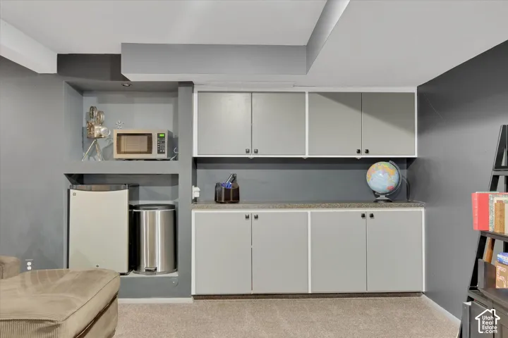 Built-in custom cabinetry with light gray doors and black hardware