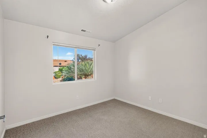 Carpeted room with a double-pane window