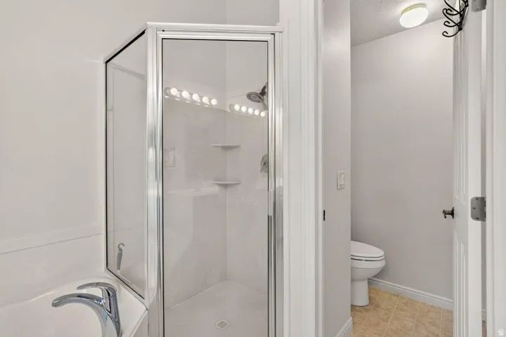 Shower-tub combination with glass enclosure and chrome fixtures