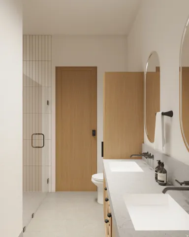 Bathroom featuring a dual vanity with undermount sinks and wall-mounted faucets