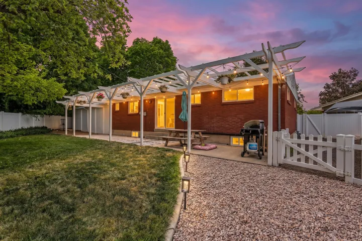 Brick exterior with a covered patio area featuring string lights