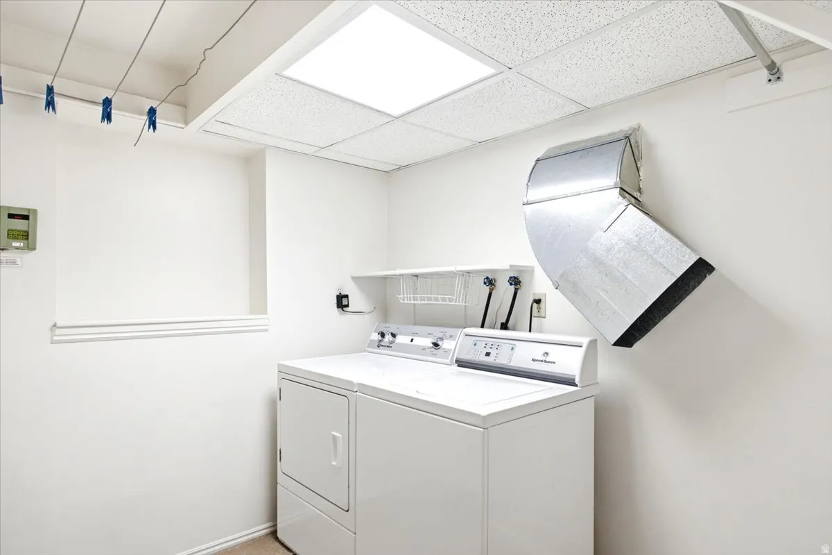 Bright open laundry room with functional clothes lines and laundry shoot