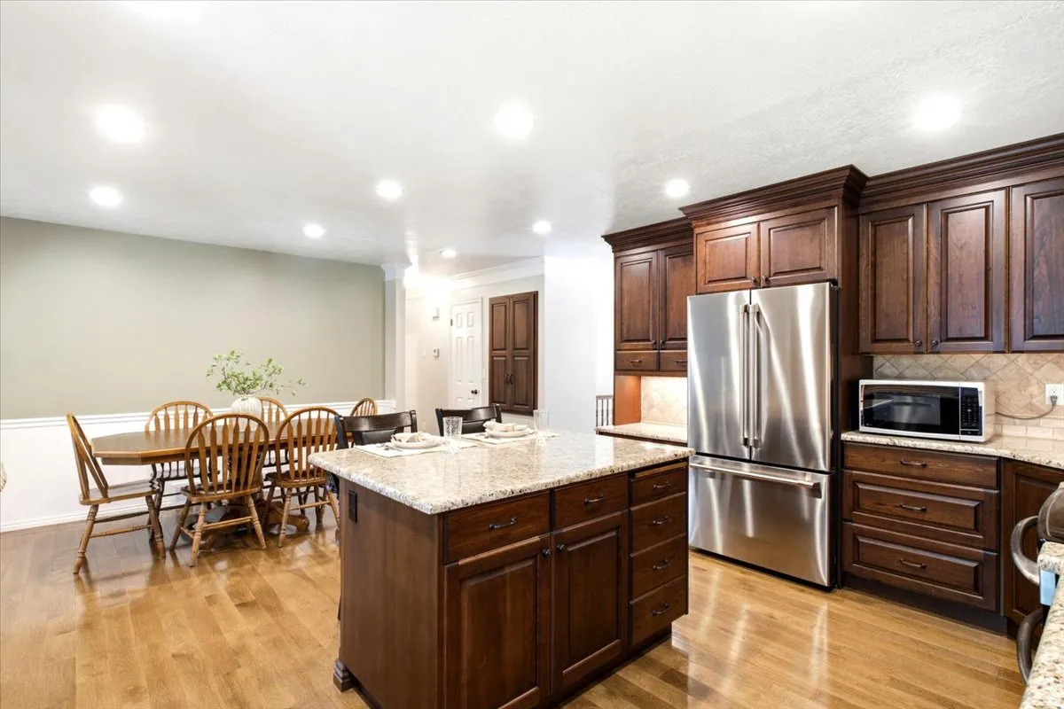Large Island and dining area with extra LED recessed lights for a bright open feel, 2 built-in storage spaces in hall.
