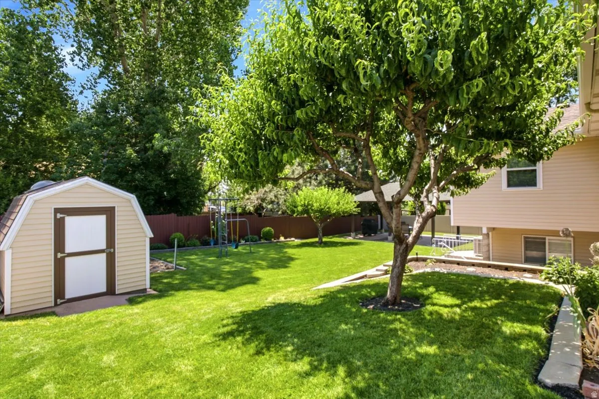 Beautiful well maintained backyard with shed, garden area, gazebo, peach and apple trees, raspberry bushes, and access to walkout basement