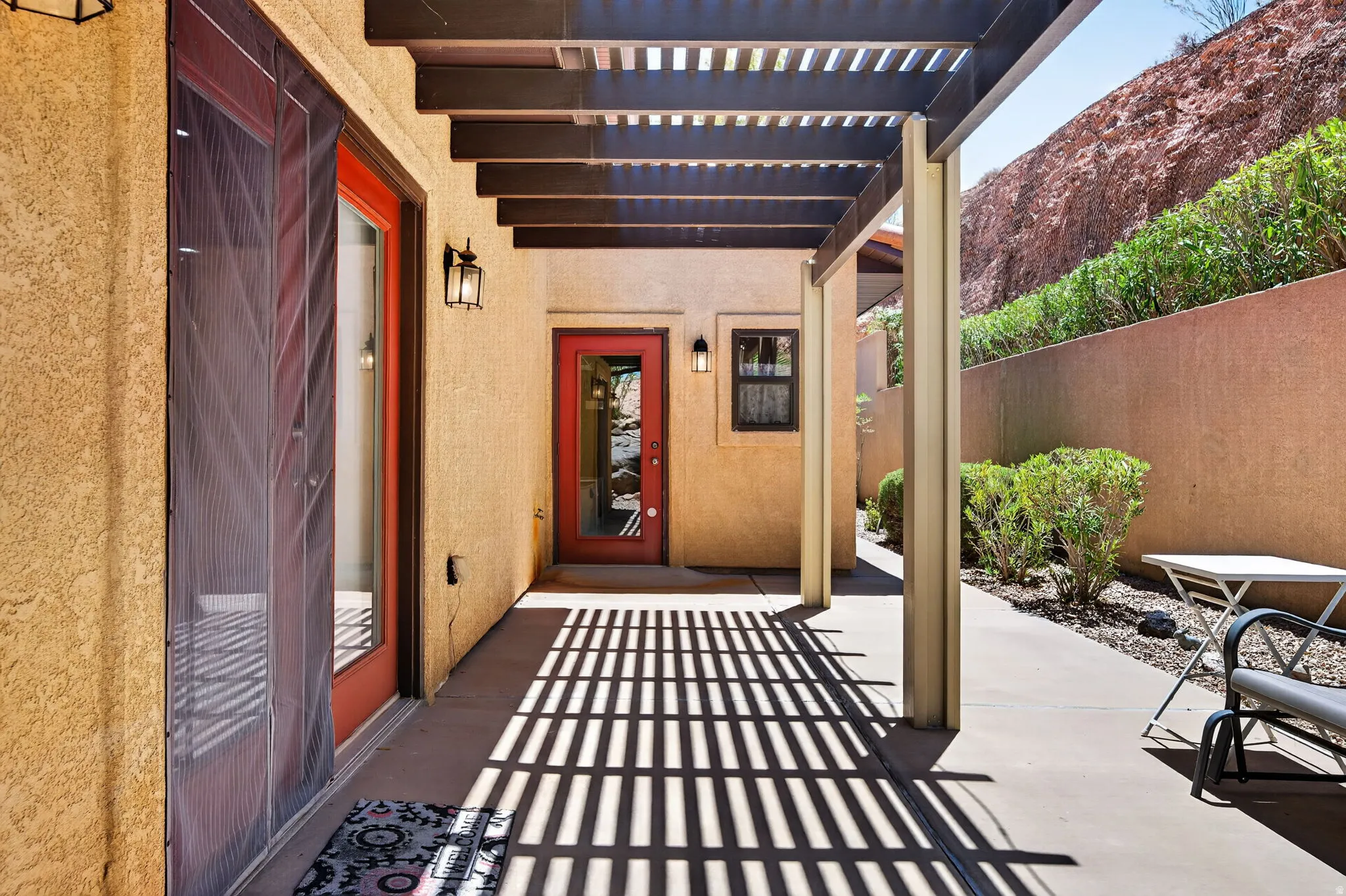 Patio area featuring a wood pergola and concrete flooring