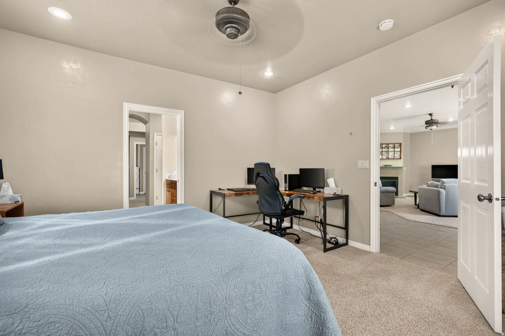 Carpeted room with neutral wall tones, recessed lighting, and a ceiling fan