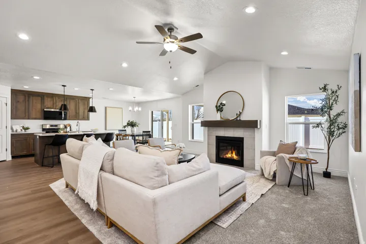 Open-concept living area with vaulted ceilings and recessed lighting