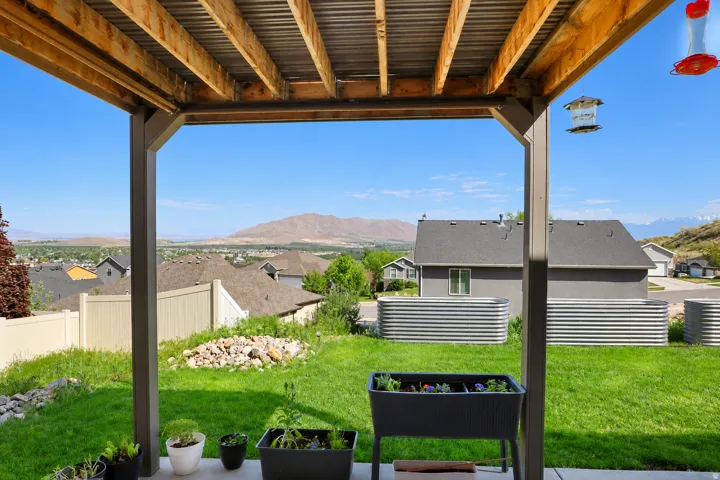 Covered patio featuring exposed wood beam ceiling and structural posts