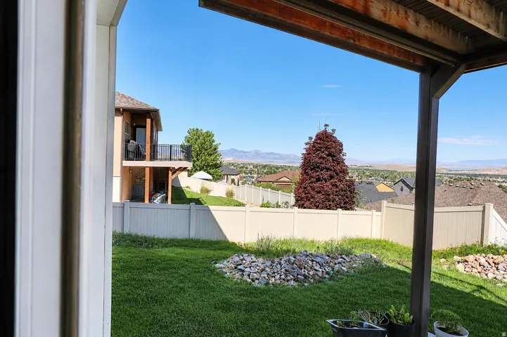 Covered patio with exposed wood ceiling beams and structural posts