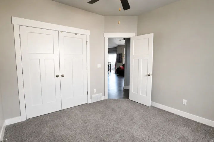 Interior room featuring neutral wall paint and plush gray carpeting
