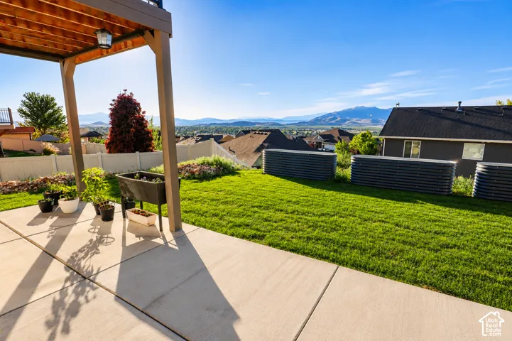 Concrete patio under a wood-paneled covered deck